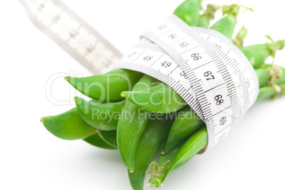 peas and measure tape isolated on white