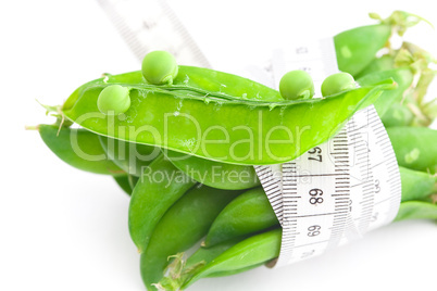 peas and measure tape isolated on white