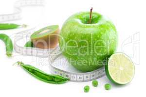 apple,lime,peas,kiwi and measure tape isolated on white