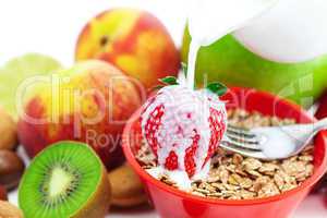strawberry, peach, apple, kiwi, fork, milk and flakes in a bowl