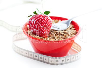 strawberry,milk,fork,measure tape and wheat in a bowl isolated o