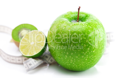 lime,apple with water drops,kiwi and measure tape isolated on wh