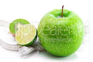 lime,apple with water drops,kiwi and measure tape isolated on wh