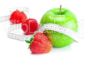 big juicy red ripe strawberries,measure tape and apple  isolated