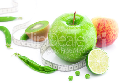 apple,lime,peas,kiwi ,peach and measure tape isolated on white