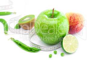 apple,lime,peas,kiwi ,peach and measure tape isolated on white