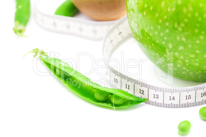 apple,lime,peas,kiwi and measure tape isolated on white