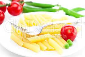 tomatoes, peas, pasta and fork on a plate isolated on white