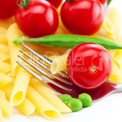 tomatoes, peas, pasta and fork on a plate isolated on white