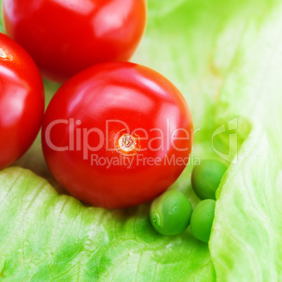 tomato,peas and lettuce on a plate isolated on white