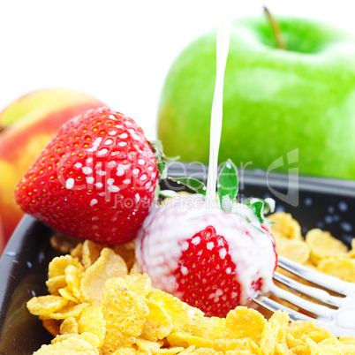 strawberry, peach, apple, kiwi, fork, milk and flakes in a bowl