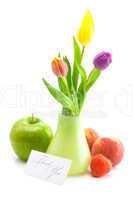 colorful tulips in vase,strawberries,apple,peach and a card sign