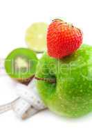 strawberries,apple with water drops,kiwi and measure tape isolat
