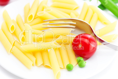 tomatoes, peas, pasta and fork on a plate isolated on white