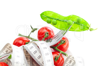 tomato,fork ,peas and measure tape on a plate isolated on white