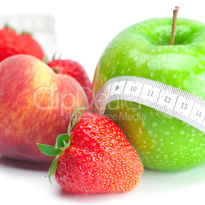 big juicy red ripe strawberries,apple,peas,peach and measure tap