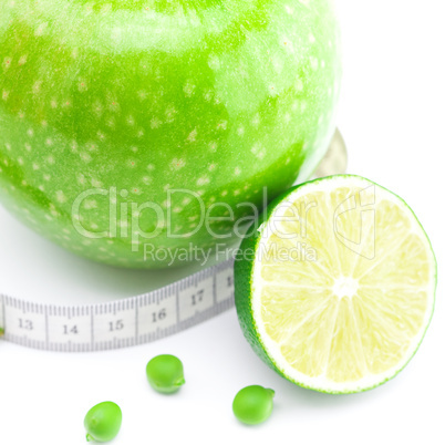 apple,lime,peas and measure tape isolated on white