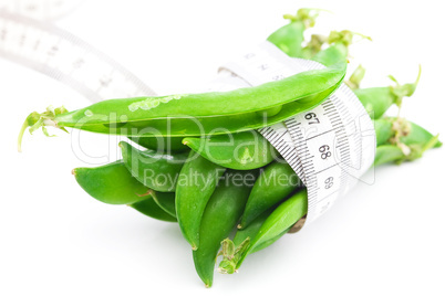 peas and measure tape isolated on white