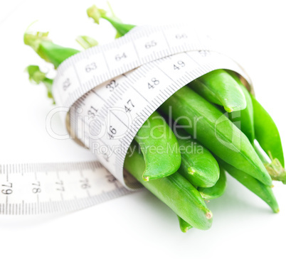 peas and measure tape isolated on white