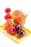 waffles, cherry, strawberry, apricot and raspberry isolated on w