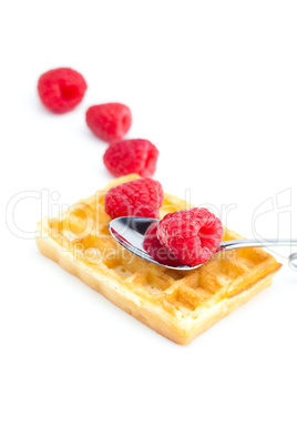 wafers,spoon and raspberry isolated on white