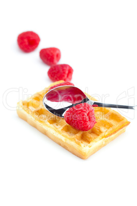 wafers,spoon and raspberry isolated on white