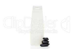 cosmetic containers and spa black stones isolated on white