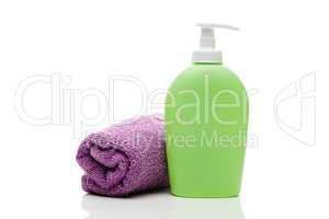 cosmetic containers and towel isolated on white