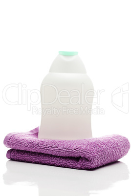 cosmetic containers and towel  isolated on white