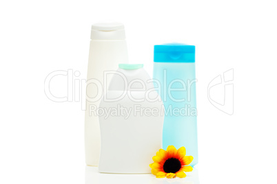 cosmetic containers and flower isolated on white