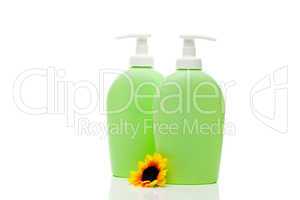 cosmetic containers and flower isolated on white