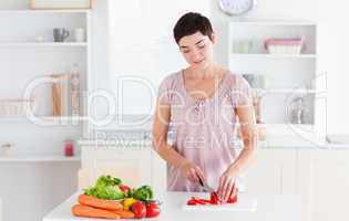 Brunette woman cutting vegetables