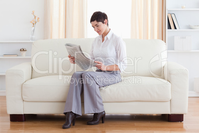 Gorgeous brunette reading the news