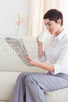 Portrait of a woman drinking coffee while reading the news