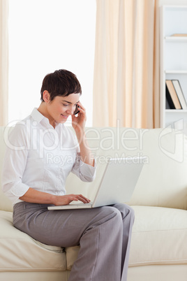 Cute Woman with a laptop and a phone