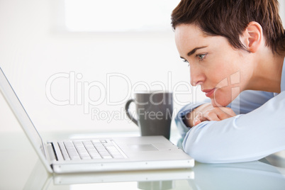 Cute woman with a laptop and a cup