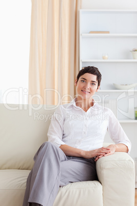 Charming woman sitting on a sofa