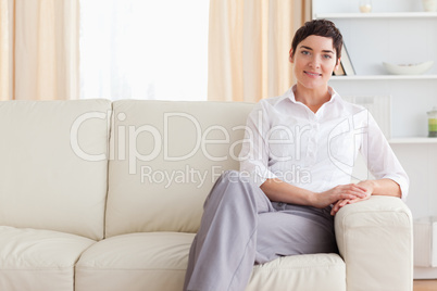 Smiling woman sitting on a sofa