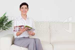 Brunette woman reading a magazine