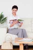 Charming woman reading a magazine