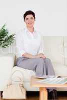 Cute short-haired woman sitting on a sofa