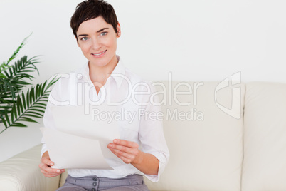 Smiling woman with a paper