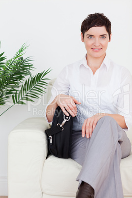 Short-haired businesswoman sitting on a sofa
