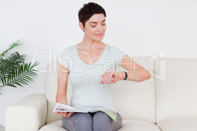 Smiling short-haired Woman with a magazine