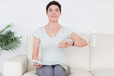 Brunette short-haired Woman with a magazine
