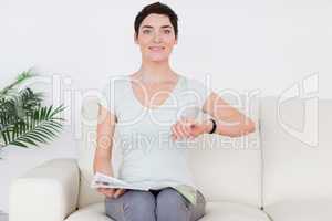 Brunette short-haired Woman with a magazine