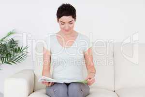 Brunette short-haired Woman with a magazine