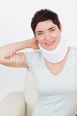 Close up of a brunette woman with a surgical collar