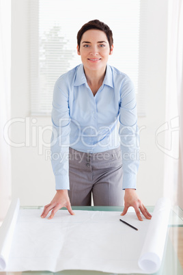 Smiling businesswoman with a architectural plan