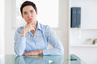 Thoughtful Businesswoman sitting behind a desk